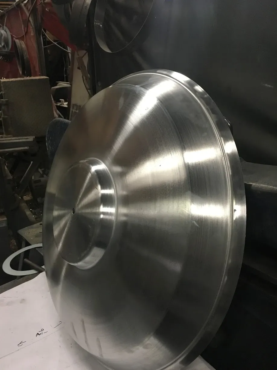 Finished spun aluminum cover with a stepped center, polished by the spinning process