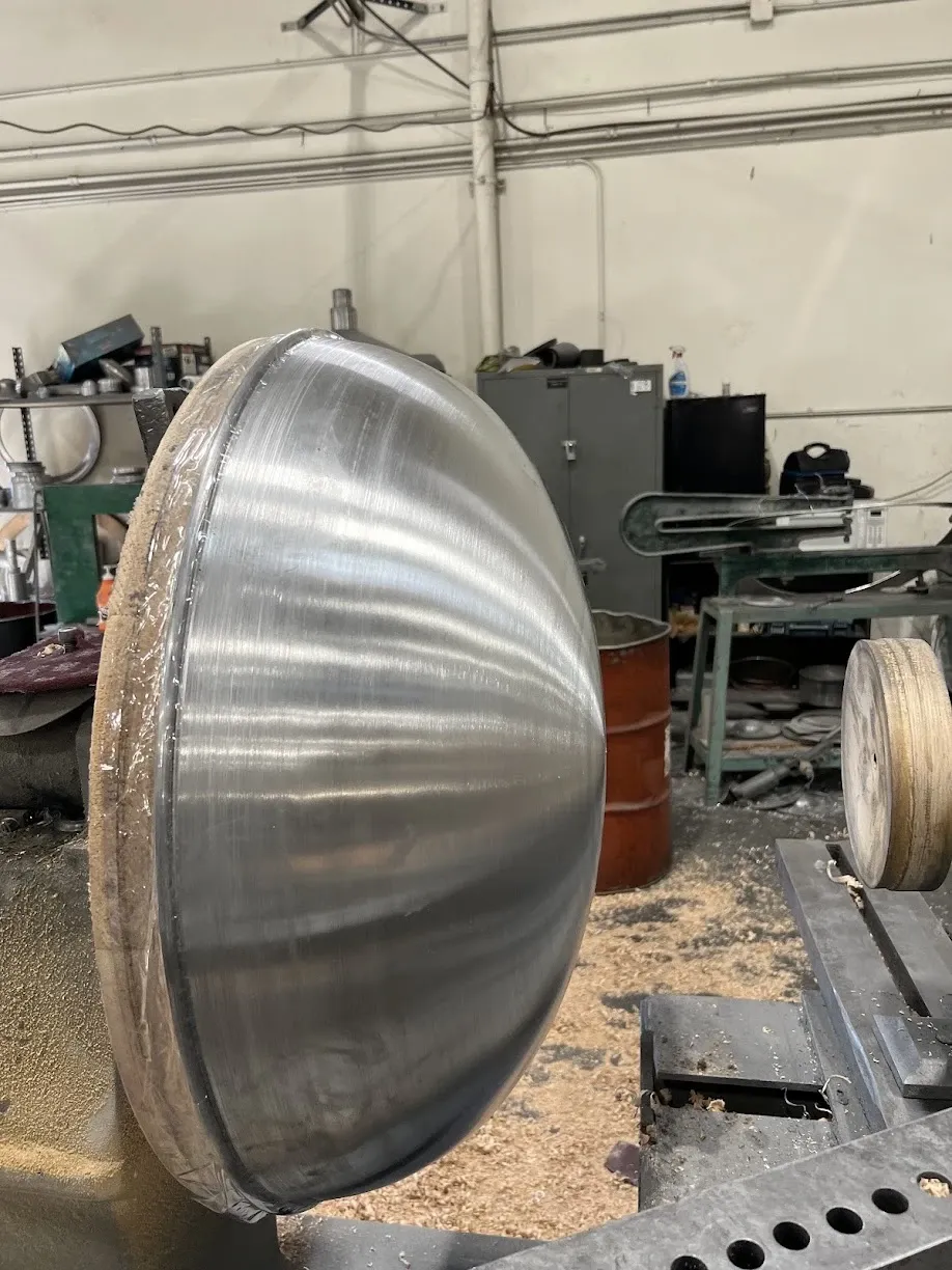 Polished aluminum dome still mounted on the spinning lathe